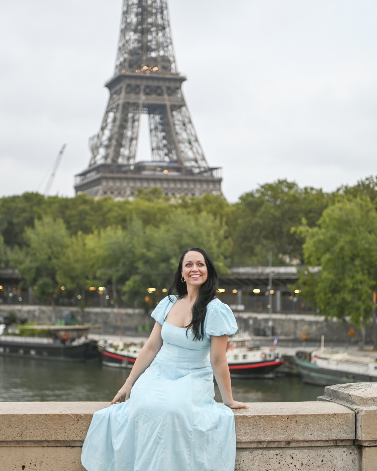 Amanda in a blue dress in front of the Eiffel Tower
