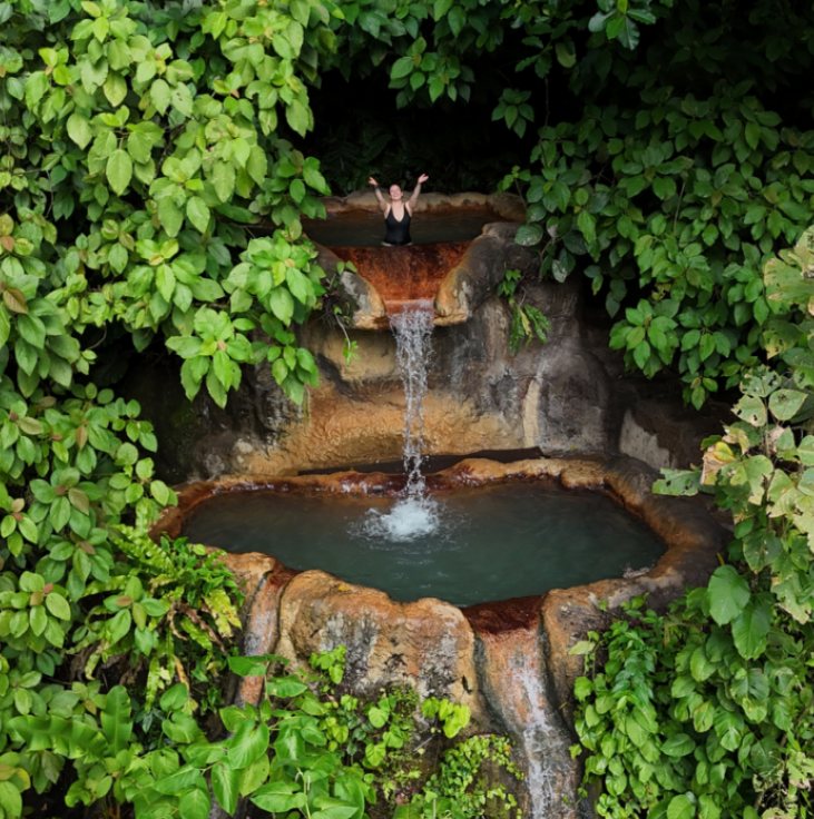 Amanda at the top of a jungle waterfall pool