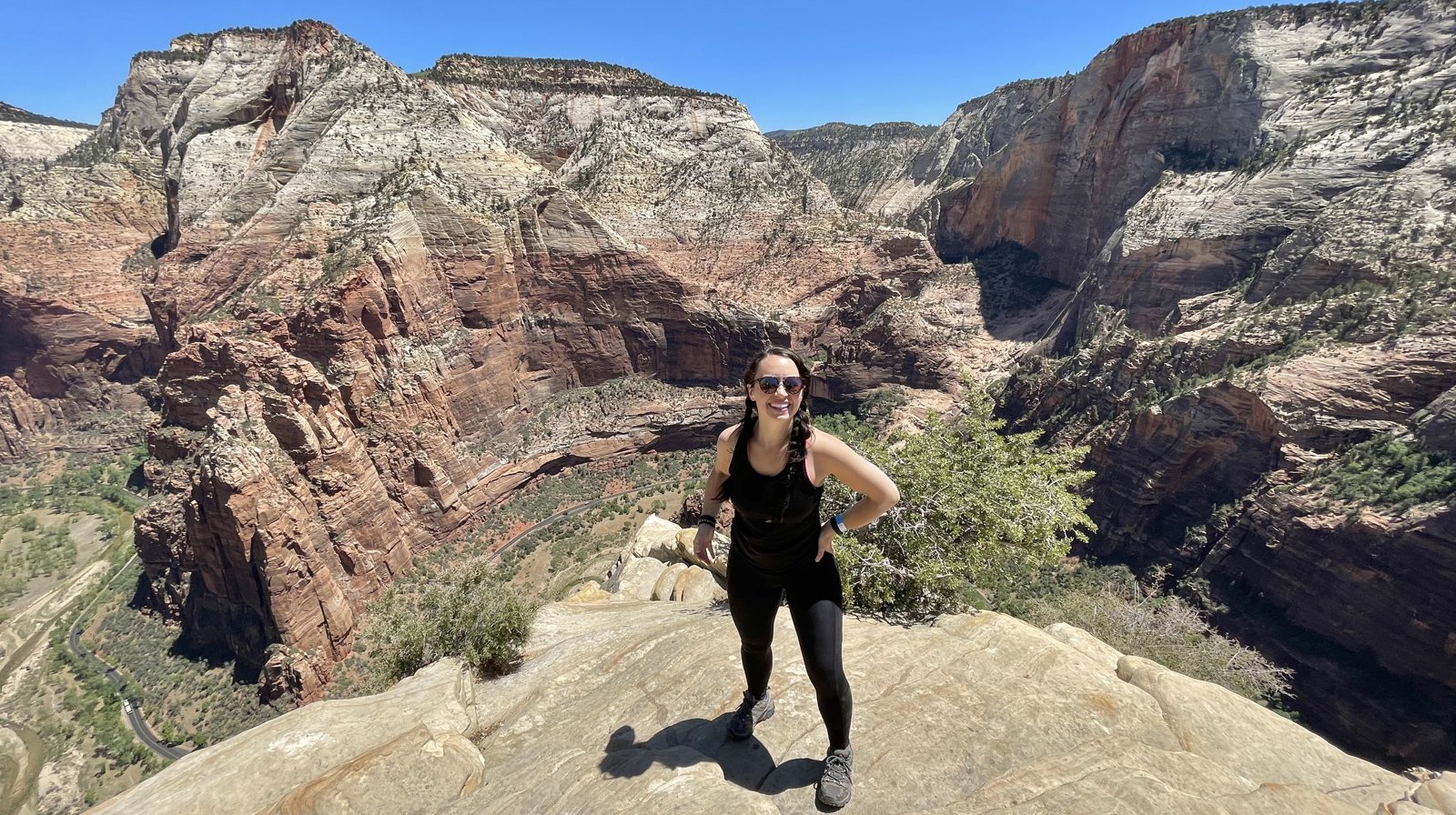 Amanda standing on a cliff edge above a red rock canyon